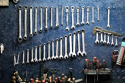 [Alt Text: Tools hanging on a wall that can be used to repair and work on vehicles.]
